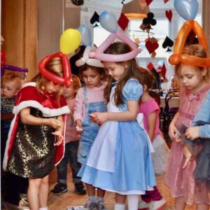 Children's dressed as Alice In Wonderland wearing Balloon Hats